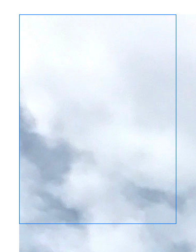 An image that shows a frame with a blue border overlaid on an image of a water wheel. The image is so much larger than the available space that only a portion of the sky and clouds from the upper left of the original image is visible. The image goes beyond the borders of the outline.