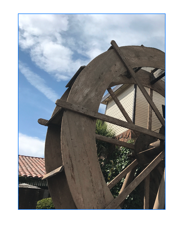 An image that shows a frame with a blue border overlaid on an image of a water wheel. The water wheel image fills the entire frame vertically and horizontally. The right side of the image is cut off at the right side of the rectangle.